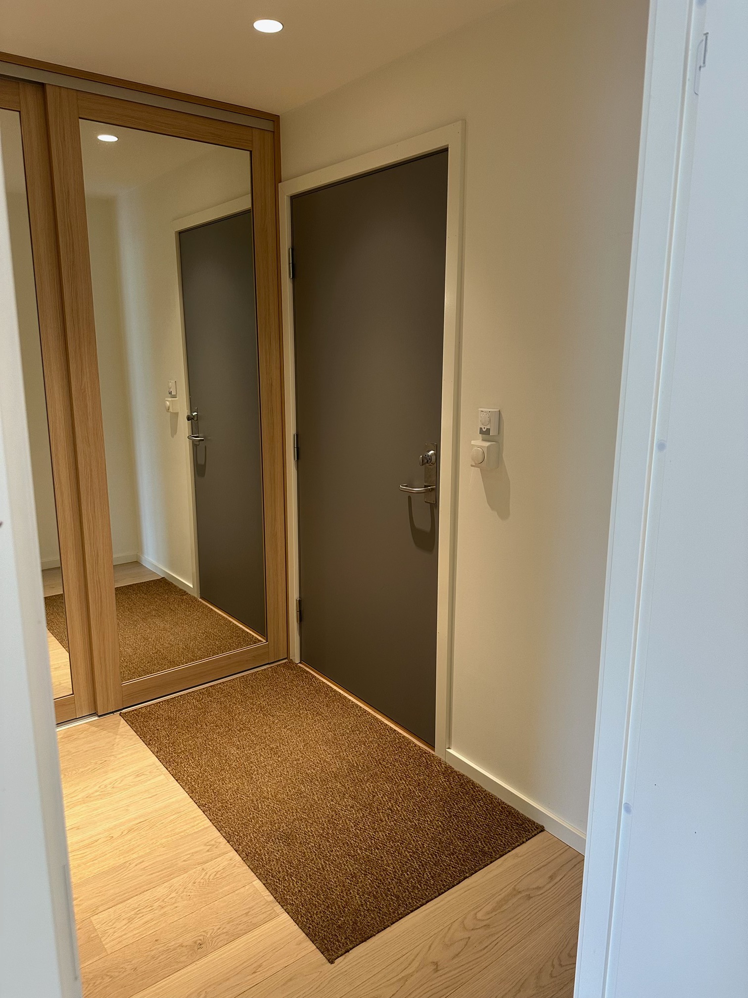 Gang med stor skyvedørsgarderobe.